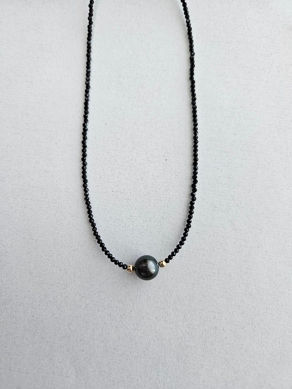 Handcrafted Tahitian pearl necklace with black spinel and gold accents