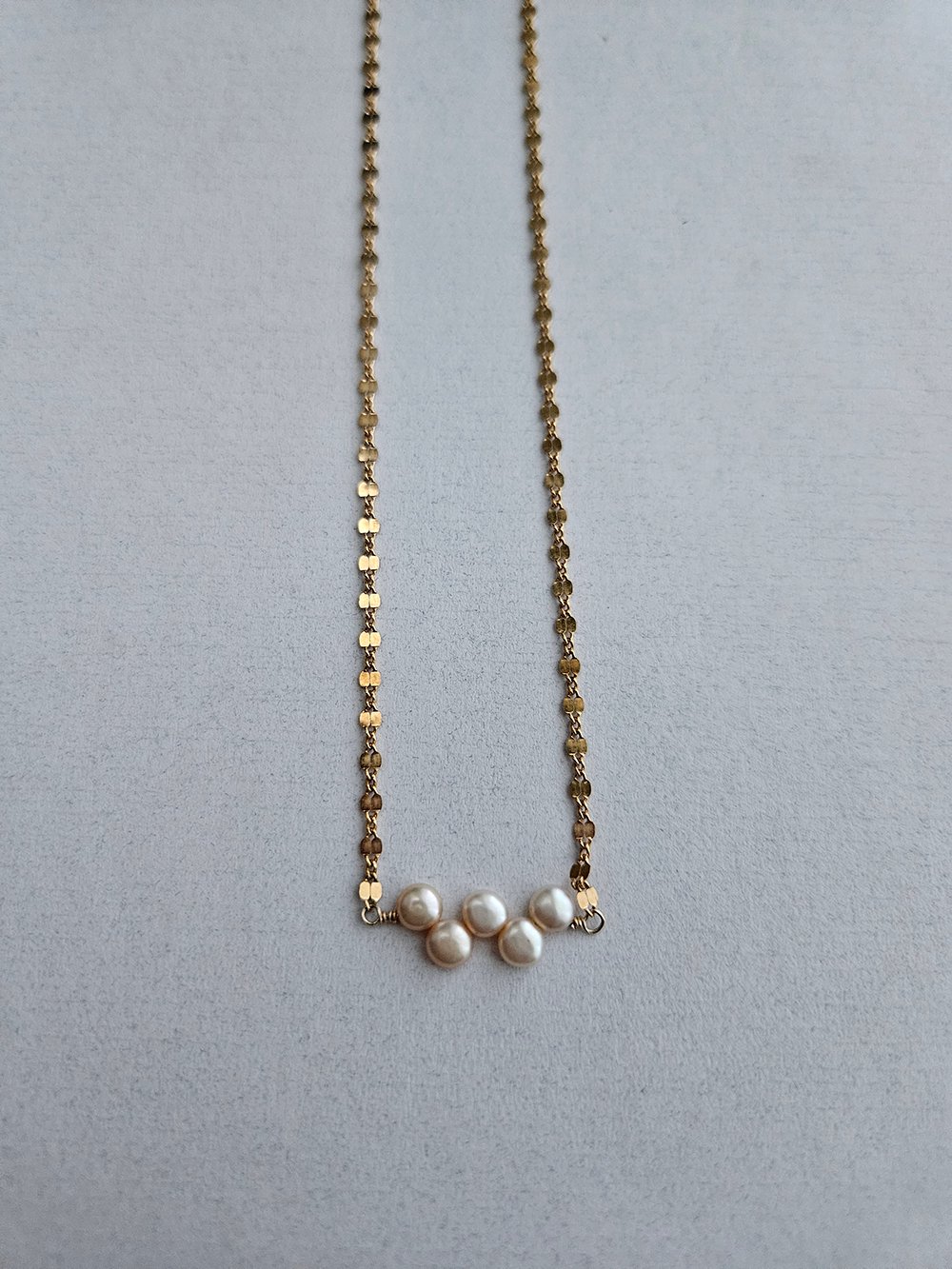 Handcrafted freshwater pearl necklace with champagne pearls on sunburst stations