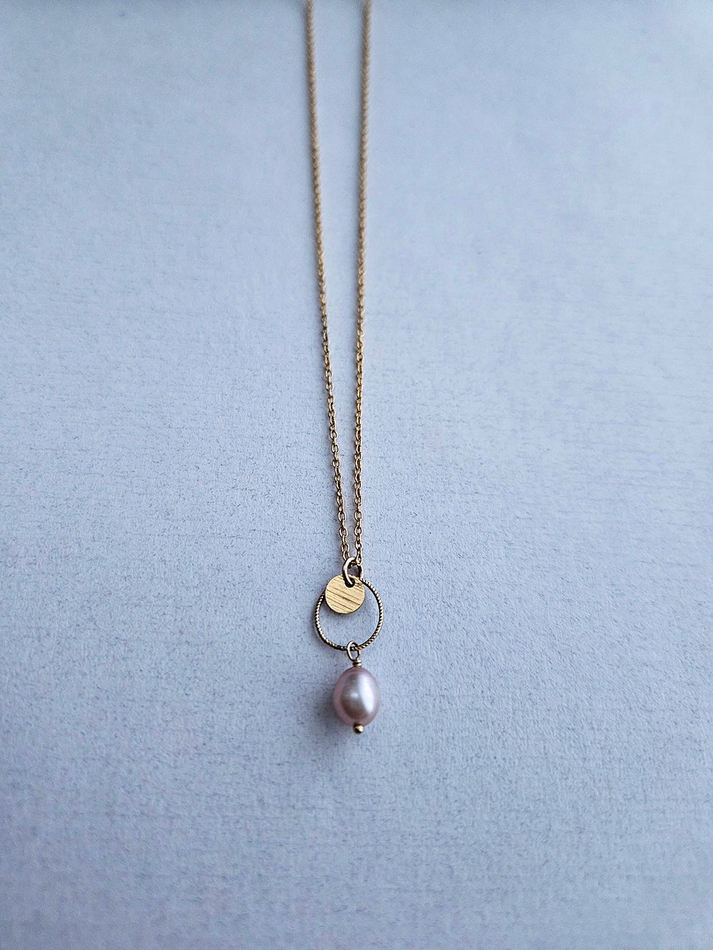 Short Image Alt Text (Picture Description) Handcrafted freshwater pearl necklace with cream pearl on circle link and gold disc